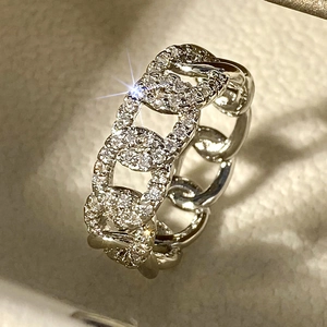 Macro shot of silver interlocking chain link ring with micro-paved white zircons