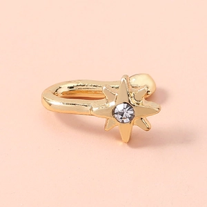 Macro view of gold star-shaped non-piercing nose ring clip with clear sparkling zircon