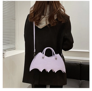 Model view of the purple bat-shaped PU leather crossbody bag showing size and fit