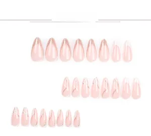 Detail of 24 pink almond fake nails with gold glitter french tips and wavy lines