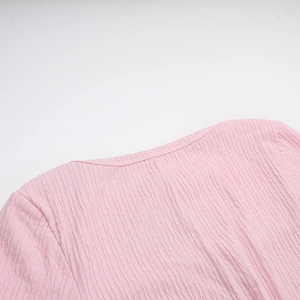Detail of the pink crinkle fabric texture and high-quality crew neck tailoring