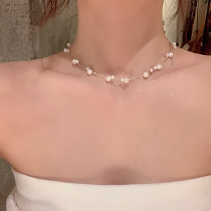 Detail of double-layer pearl choker with irregular pearls on a gold chain necklace