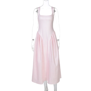 Detailed view of the pink plaid pattern and pleated waist on this midi camisole dress