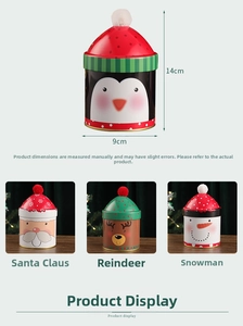 Detail view of 14cm Christmas tin box showing festive Santa and Reindeer designs with pom-poms