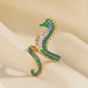 Golden seahorse ring with green and blue enamel details in an adjustable open design