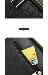 Detail of the back zipper pocket on a black litchi leather bag with gold hardware