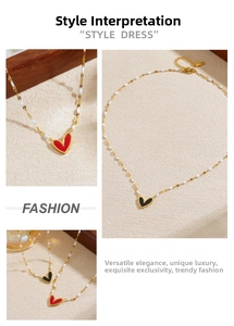 Detail of red and black heart pendants on a gold chain with white bead accents