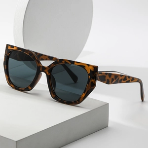 Chic tortoise shell oversized sunglasses with angular frames on minimalist white background