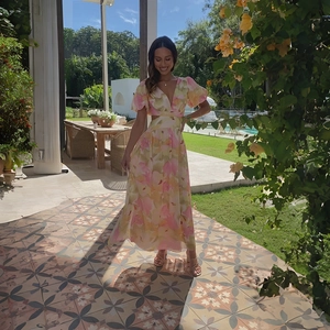 Detail of floral maxi dress with side waist cut-out and elegant gradient flower patterns