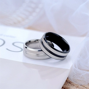 Macro detail of brushed stainless steel rings with sleek matte finish and silver-black dual tones