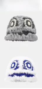 Detail view of winter plush crochet flower bucket hats in grey and white faux rabbit fur
