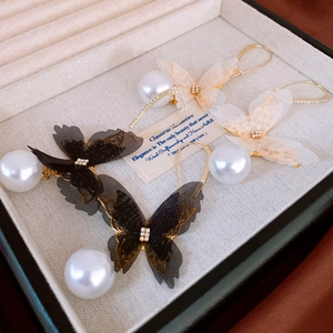 Elegant lace butterfly earrings with crystals and hanging pearls in a jewelry display box