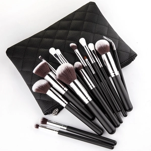Detailed view of 15 makeup brushes with black handles and a quilted zipper travel case