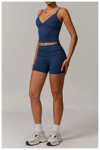 Detail of dark blue high-waist yoga shorts and V-neck tank top with thin straps