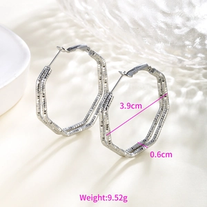 Detail view of silver hexagonal hoop earrings with textured diamond-cut finish and size specs