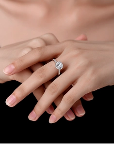 Classic silver engagement ring with halo-set moissanite shown on a model hand