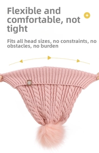 Close-up showing the high elasticity and stretch of the pink cable knit pom pom hat