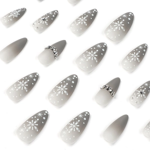 Long almond press on nails with grey gradient, winter snowflake patterns and rhinestones