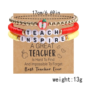 Detail of colorful polymer clay teacher bracelet set with TEACH and INSPIRE charms