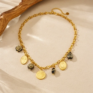 Detail of luxury gold chain necklace with black roses and religious cross charms
