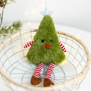 Detail view of plush Christmas tree elf hanging ornament with silver star and striped legs