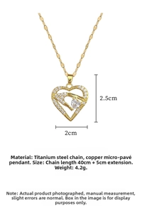Detail of gold heart pendant with hand-holding-heart design and sparkling zircon stone