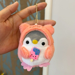 Close-up of plush penguin keychain wearing a pink bear hoodie holding an ice cream