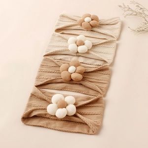 Detail view of 4-pack nylon floral headbands for babies in earthy tones and textures