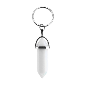 Natural white crystal hexagonal column keychain with silver metal ring on white background