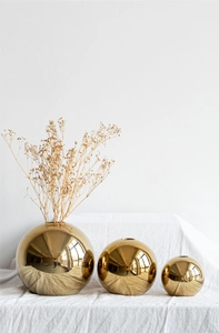 Three gold ceramic spherical vases in small, medium, and large sizes for elegant home decor