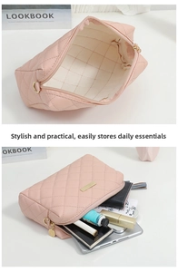 Detail of pink quilted PU leather makeup bag with gold zipper and organized interior