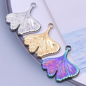 Detailed trio of ginkgo leaf pendants in silver, gold and iridescent steel finishes