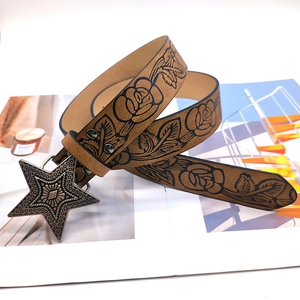 Vintage brown leather belt with embossed roses and a metallic star-shaped buckle