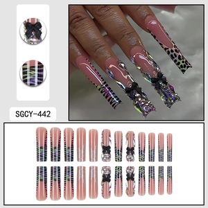 Extra long leopard print press-on nails with 3D black bows and colorful gems