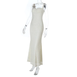 Close-up of ivory lace texture and 3D floral strap details on a slim maxi dress