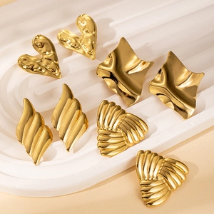 Detailed view of gold geometric wavy and heart-shaped stainless steel earrings