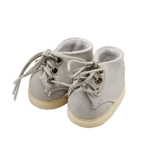 Macro shot of light gray faux suede doll shoes with beige soles and gray laces