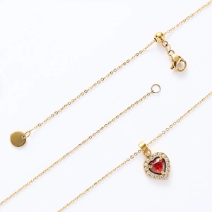 Detailed macro view of heart pendant necklace with red gemstone and adjustable lobster clasp