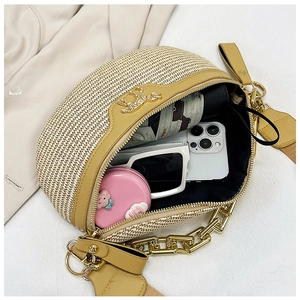Flat lay of woven waist bag showing spacious interior with phone, glasses and accessories