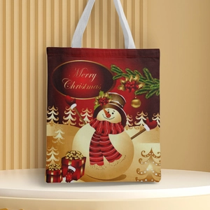 Canvas Christmas tote bag with snowman and Merry Christmas print on a white stand