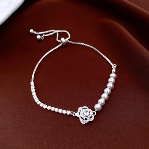Detail of zircon rose flower pendant and pearls on an adjustable silver slider bracelet