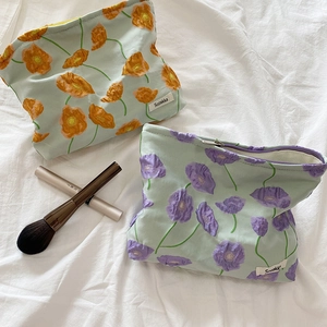 Quilted floral cosmetic bags in green with orange and purple poppy flower patterns