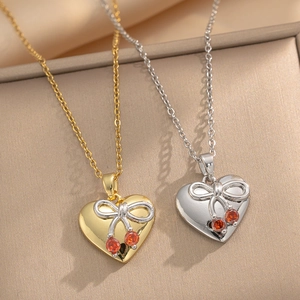 Titanium steel heart and cherry bow necklaces in gold and silver finishes