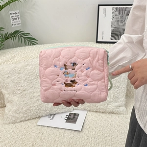 Detail of pink quilted makeup bag with dachshund embroidery and Have a nice day text