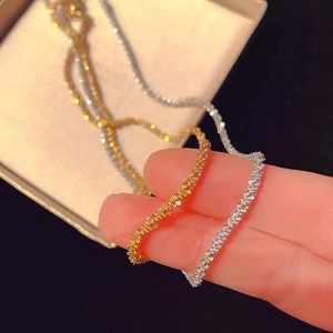 Glistening gold and silver titanium steel twist chains set with textured shimmering finish