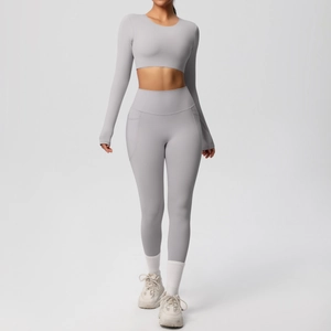 Detail view of light grey high-waisted yoga leggings with side pocket and crop top set