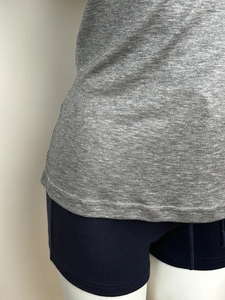 Detail shot of the hem showing knit wool texture and fine double-needle stitching quality