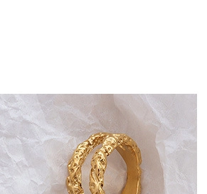 Macro shot of 18K gold-plated wide ring with a unique vintage hammered metal texture