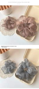 Detailed macro view of organza scrunchies in lavender and smokey grey with pleated texture