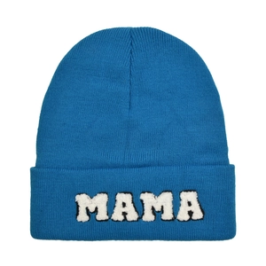 Detail of royal blue beanie featuring white MAMA boucle embroidery on the cuff